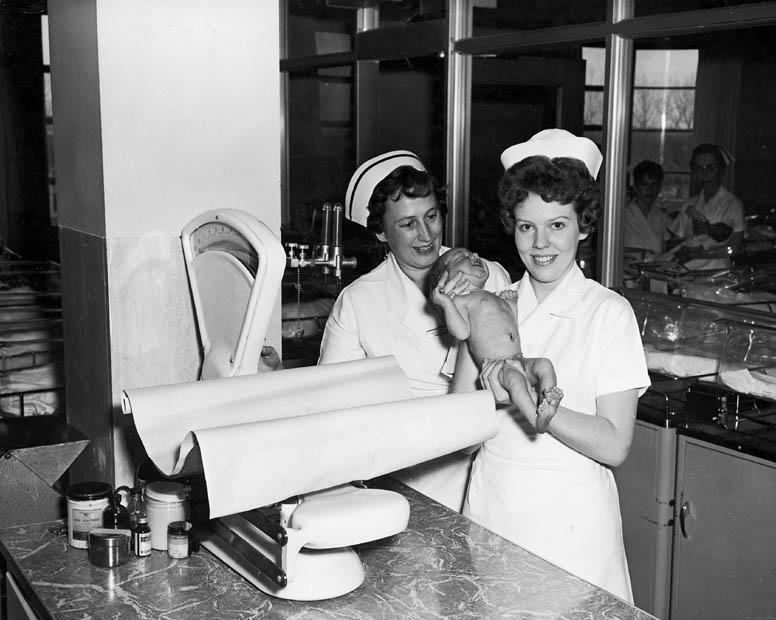 Two_nurses_with_baby_in_nursery_at_Toronto_East_General_and_Orthopaedic_Hospital_Toronto_ON